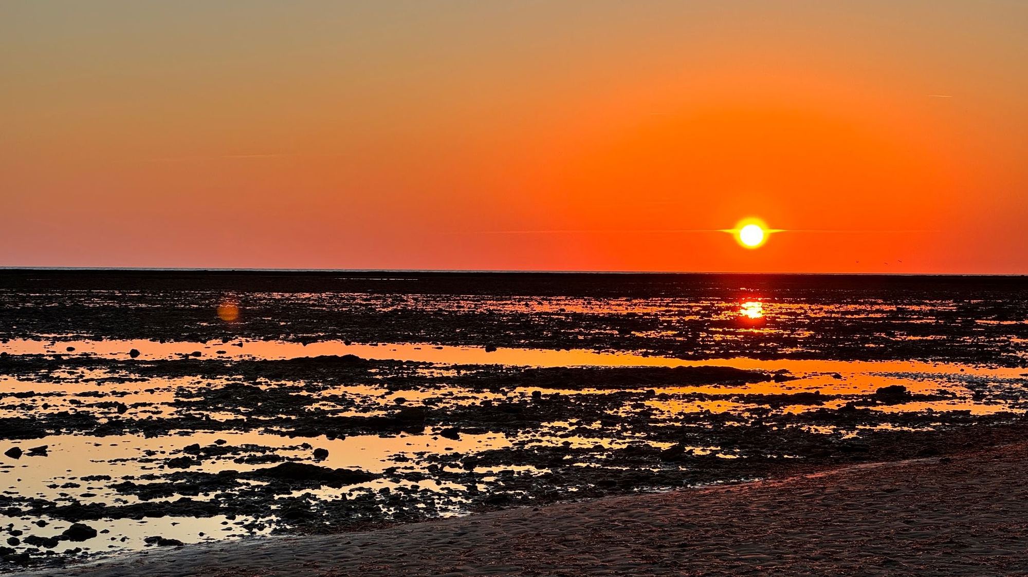 The corrales at sunset, red sky reflected in the water