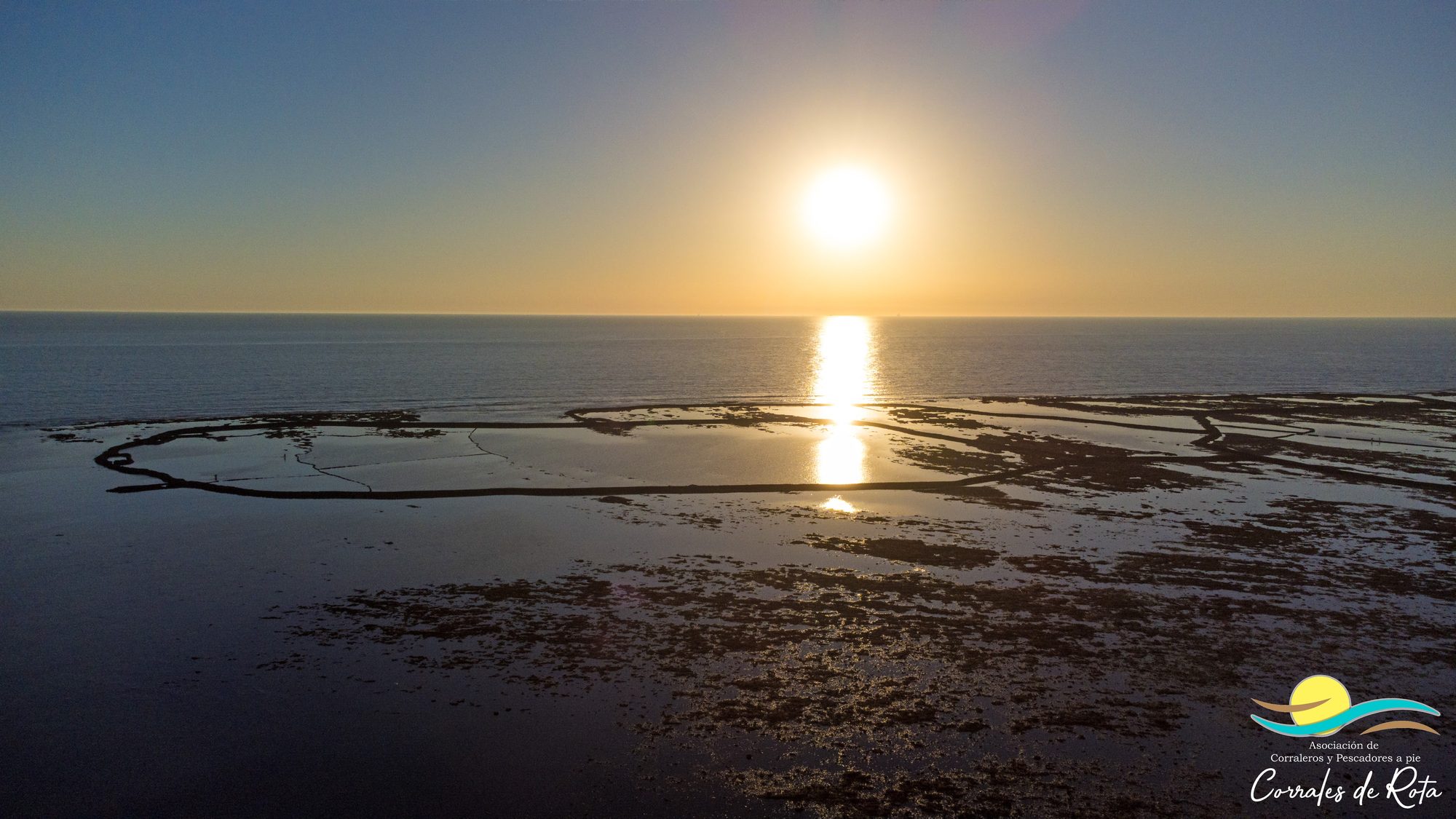 Aerial view of the tidal fish traps of Rota at low tide, at sunset